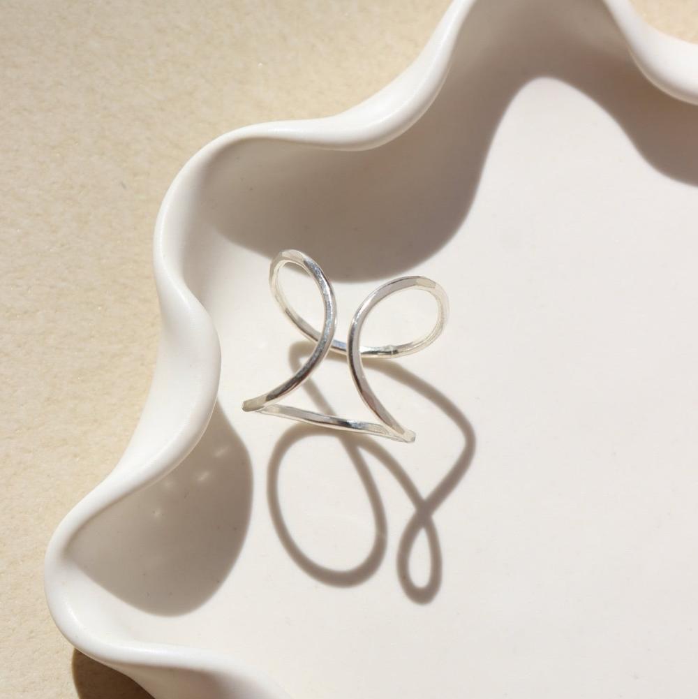 Isla Ring laid on a white plate in the sunlight.