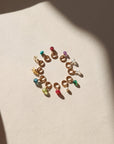 circle of tiny birthstone gemstones on jump rings in the sunlight