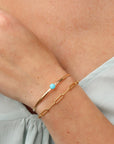 Model wearing Turquoise Skyline Cuff featuring a 6mm Sleeping Beauty turquoise cabochon on a hand-notched gold filled band.