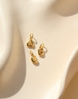 gold plated bubble letter charms in A,B,C on a white dish