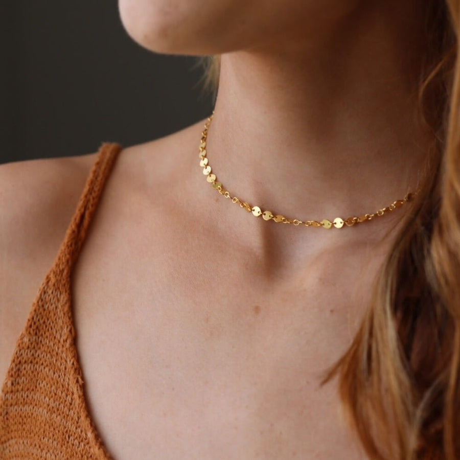 Model wearing 14k gold fill starlight choker. This choker is perfect for layering. This Necklace features circle disc that are linked together.