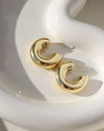14k gold fill chunky hoop studs, laid on a white plate.