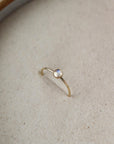 14k gold fill moonstone ring 4mm set in the sand. This ring features a simple band with a moonstone gemstone bezeled to it.