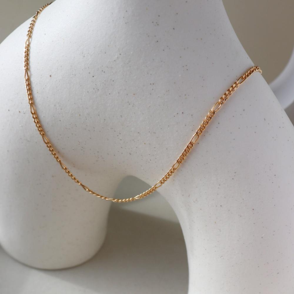 14k gold fill Capri Chain laid on a white plate. Handmade in Eau Claire Wisconsin.