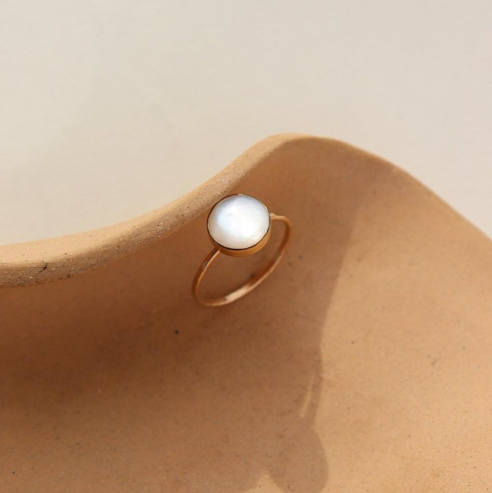 14k gold fill Mother of pearl ring on a tan plate 
