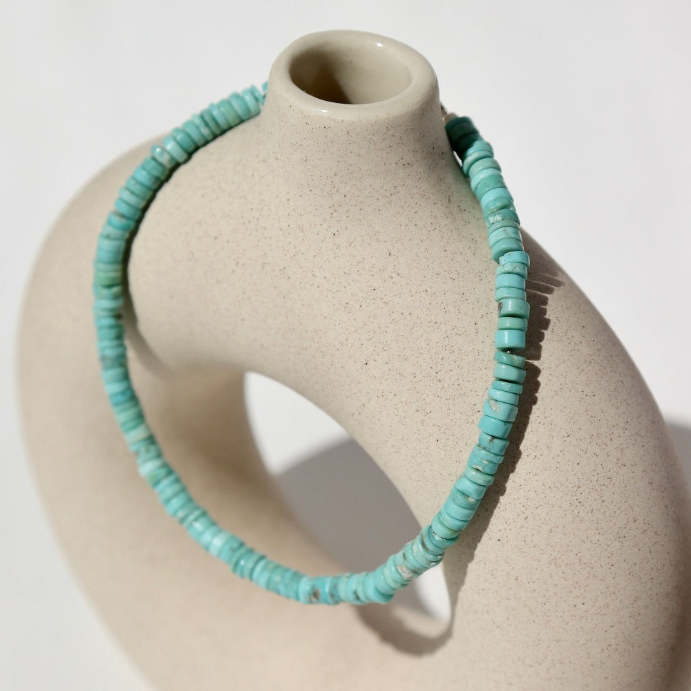 Turquoise Beaded Bracelet on a tan pot