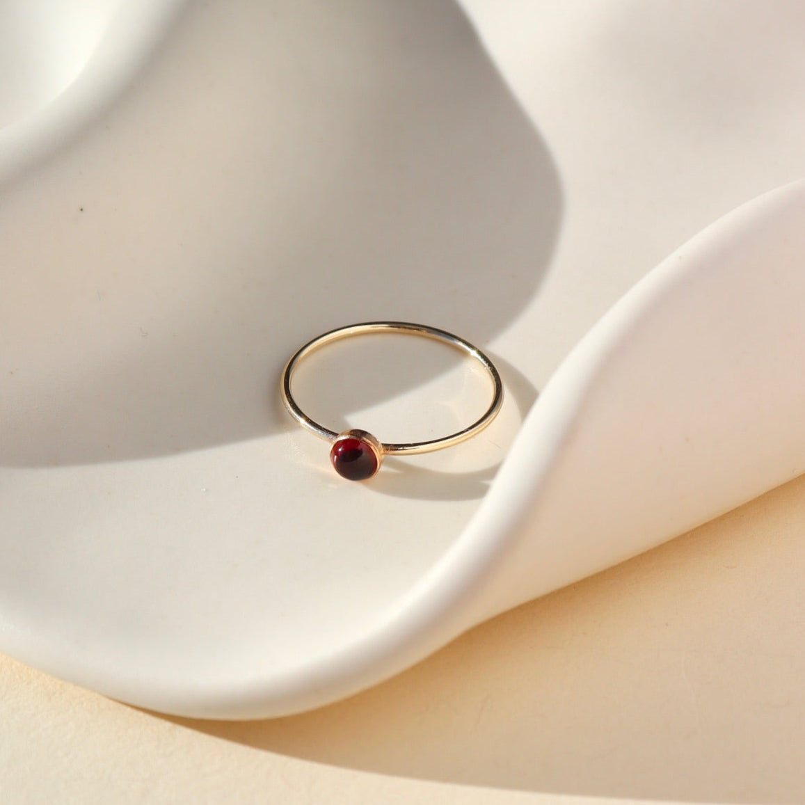 14k gold fill thin ring band with a 4mm red garnet stone