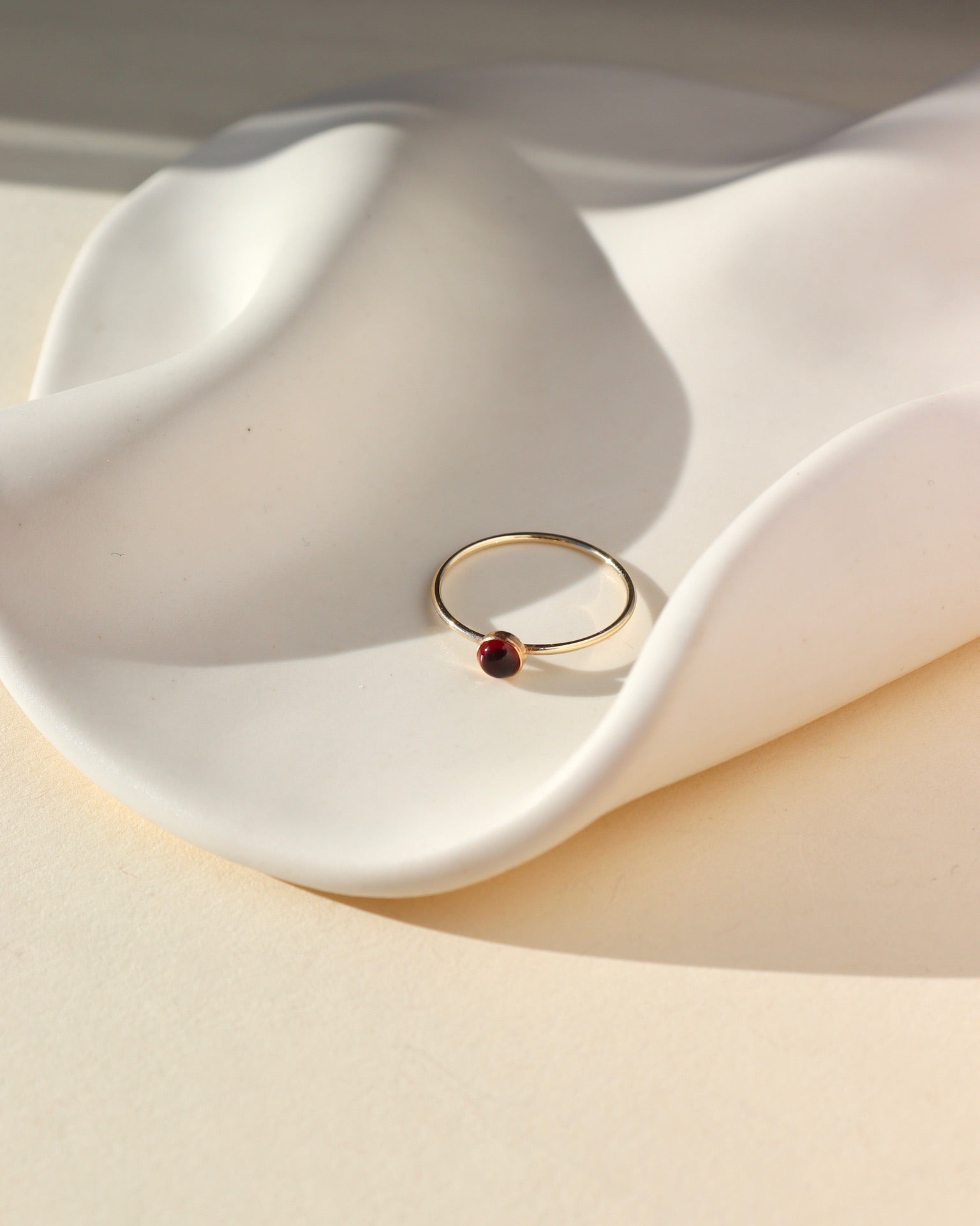 14k gold fill thin ring band with a 4mm red garnet stone