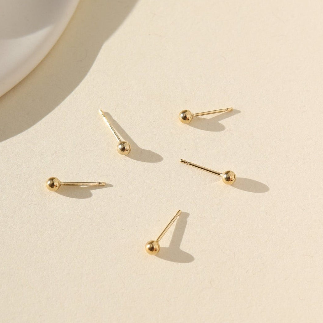 gold fill classic studs laid in the sun