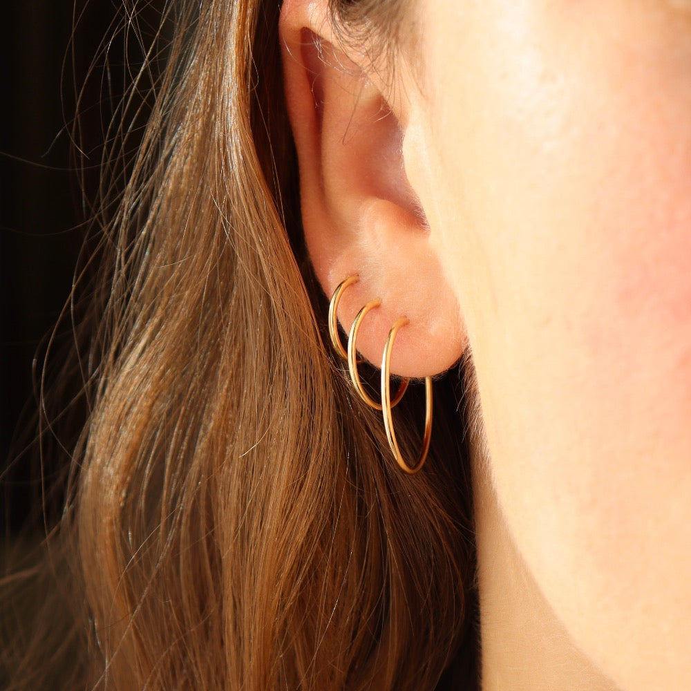 model wearing 14k gold fill goldie hoops