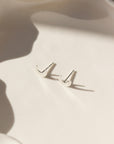 Tiny moon studs in sterling silver by Token Jewelry