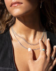Bold and chunky 925 sterling silver curb chain with a lobster clasp and 2" extender chain to make the necklace adjustable from 14" to 16", photographed on a model wearing a black denim vest and turquoise and sterling silver jewelry handmade by Token Jewelry