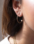 Model wearing 14k gold fill Balanced Pearl Hoops. This earring features a simple gold threader with a tiny classic pearl on the end.