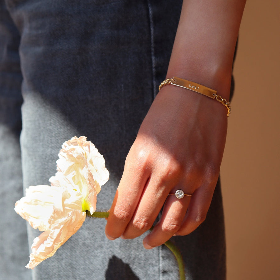 Model wearing 14k gold fill Name plate bracelet with Alexandra chain. This bracelet features a simple plate you can choose to have hammered or have smooth. This bracelet is then connected with the Alexandra chain. With this bracelet it features the option of adding a name or not.