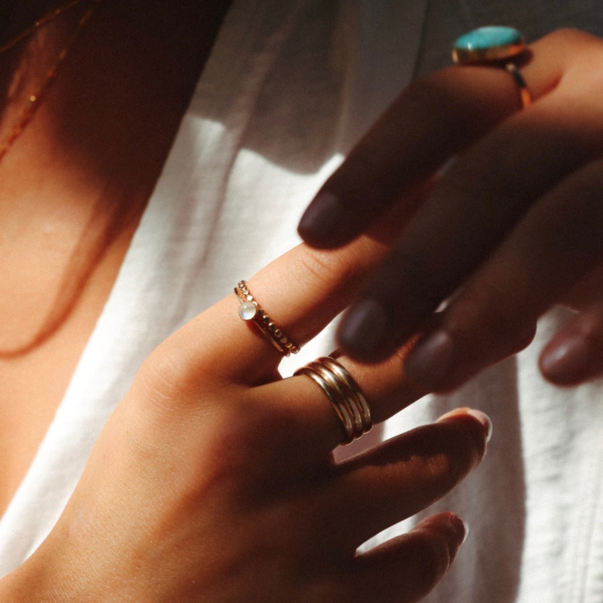 Model wearing 14k gold fill rings with a 4mm moonstone gemstone ring on a sleek minimal band. 