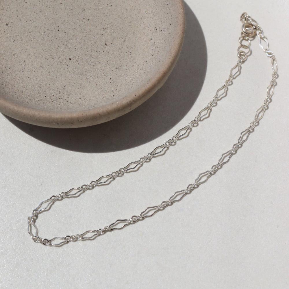 925 Sterling silver Clara Bracelet laid on a white plate
