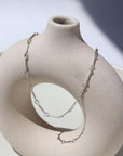 925 sterling silver Dot & Dash Anklet laid on a white pot in the sunlight.