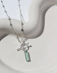 925 Sterling silver Flynn Toggle Necklace. This Necklace Features a Simple Toggle connector with a Dangle Fluorite tube gemstone . The toggle is held together with the Sylvie chain.