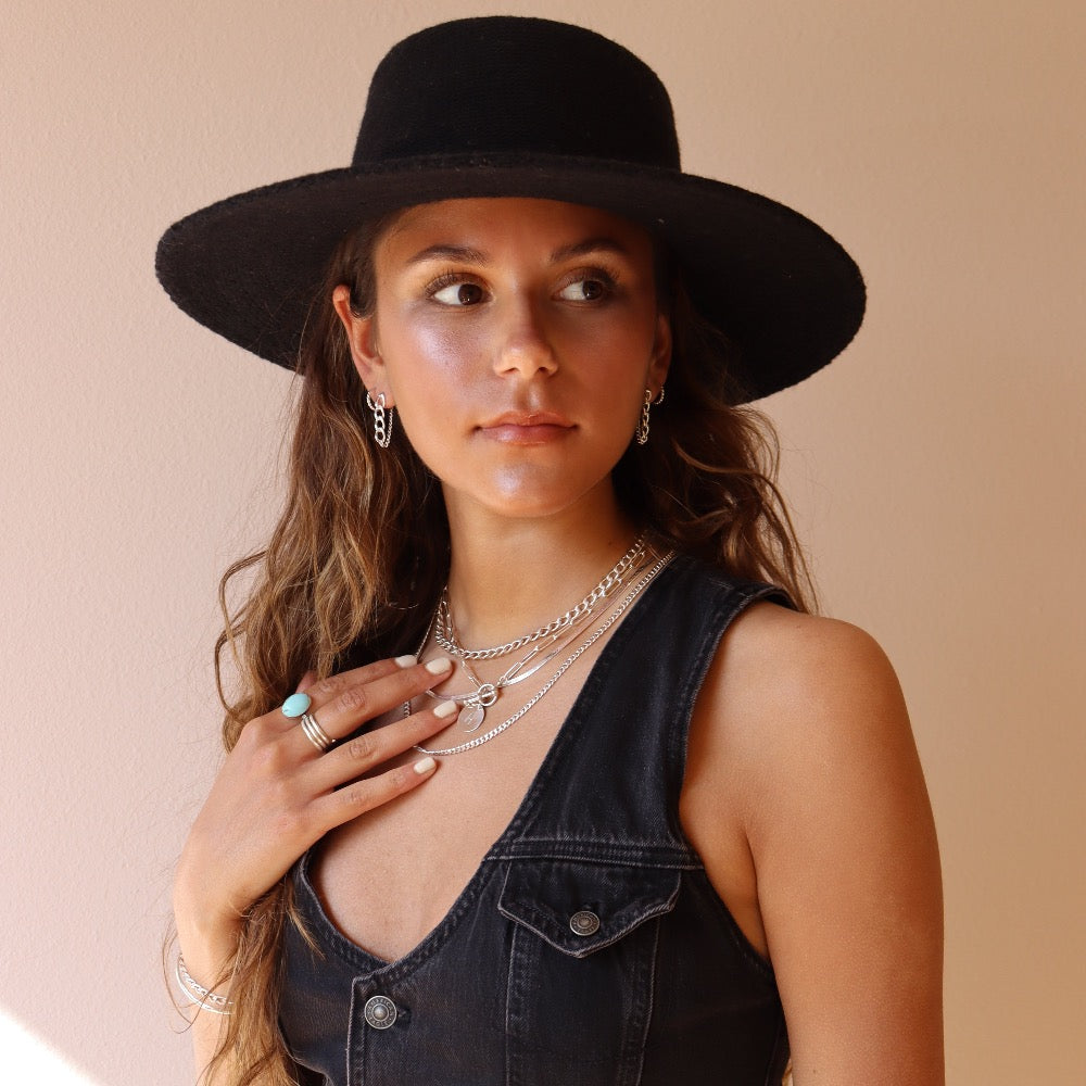 925 sterling silver chain earrings photographed on a brunette model wearing a black cowboy hat