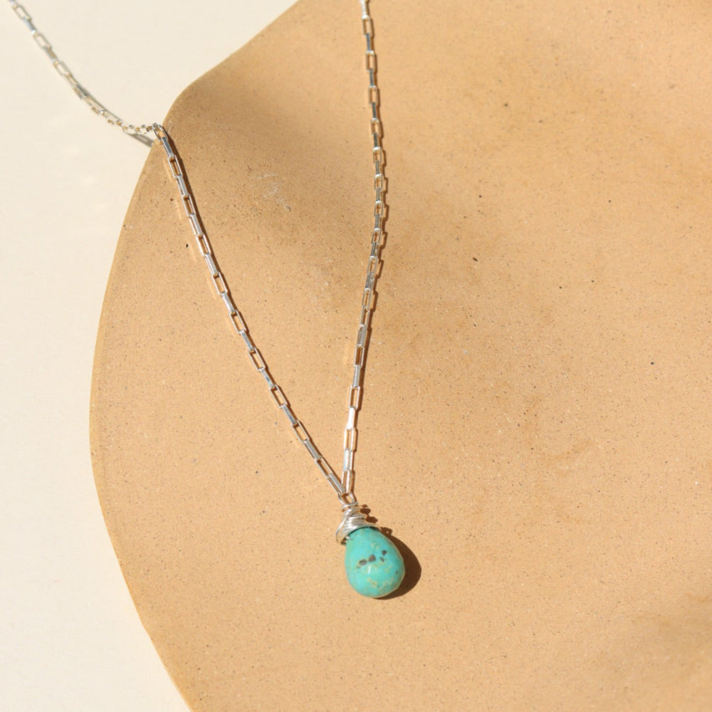 Agave Necklace with a faceted sage green turquoise teardrop pendant on a reflective sterling silver box chain, designed for everyday wear and layering.