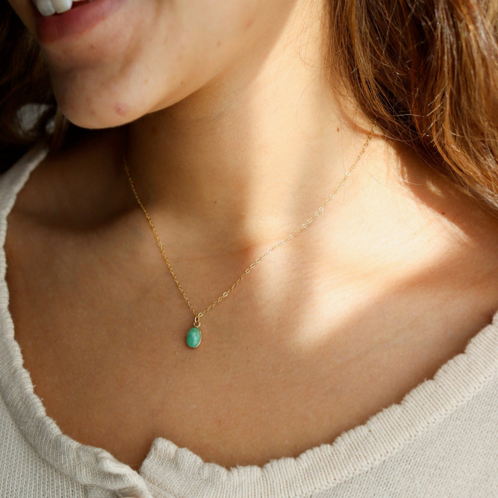 Model wearing a 6x8mm Amazonite Gemstone set in a 14k gold fill bezel. The necklace features a thin standard chin.