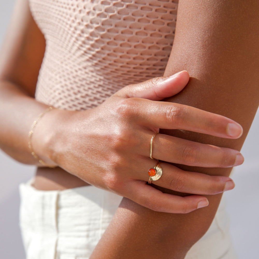 Model wearing Curved hammered stacking ring in gold fill with a rainbow-like arc shape