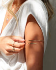 model wearing 14k gold fill arm cuff with other 14k gold fill jewelry