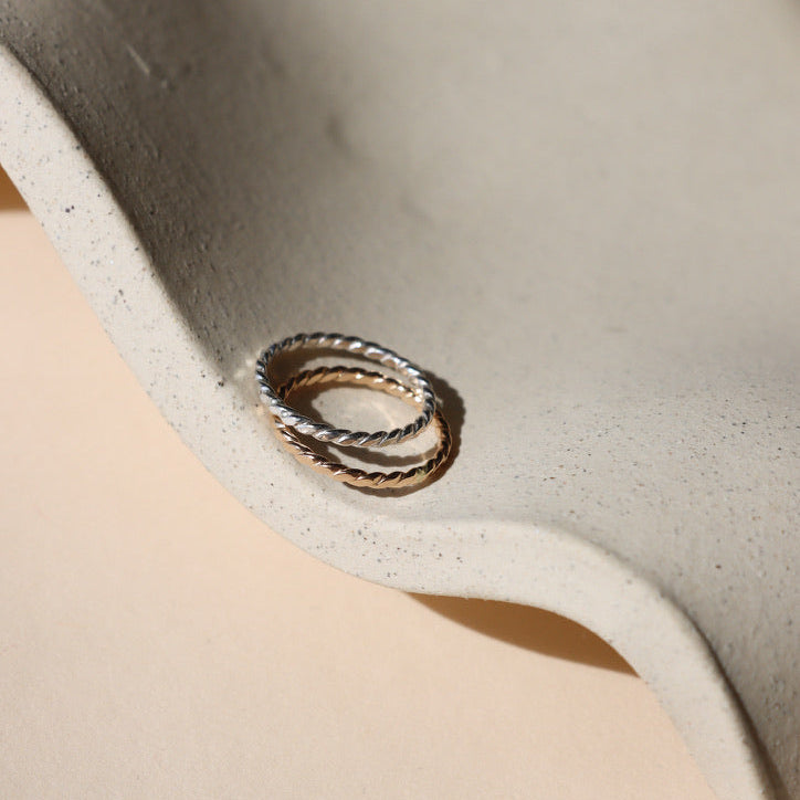 14k gold fill and sterling silver hammered spiral wire rings on a light dish