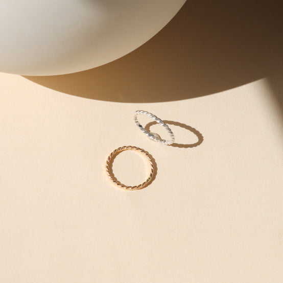 14k gold fill and sterling silver hammered spiral wire rings on a light dish