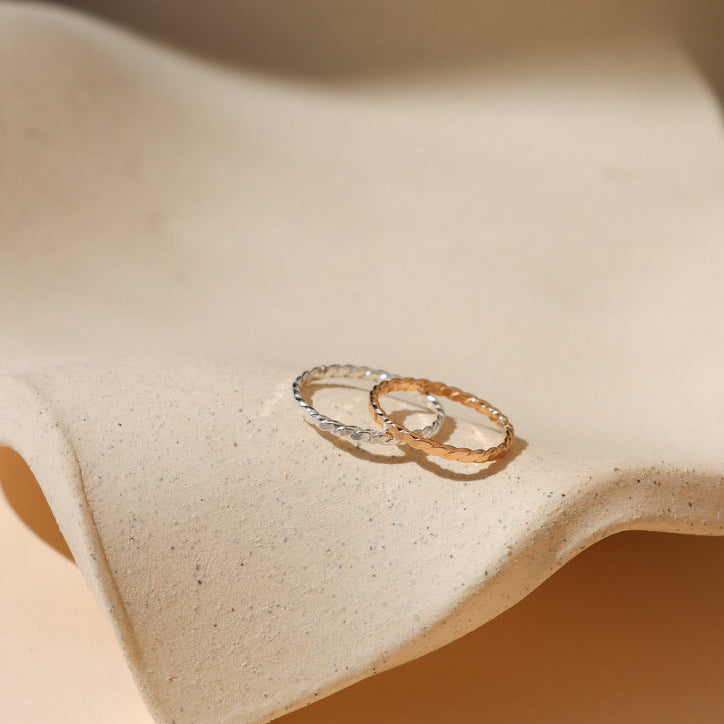 14k gold fill and sterling silver hammered spiral wire rings on a light dish