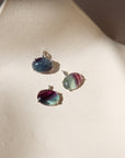 sterling silver bezel pendants with oval fluorite cabs on a light dish