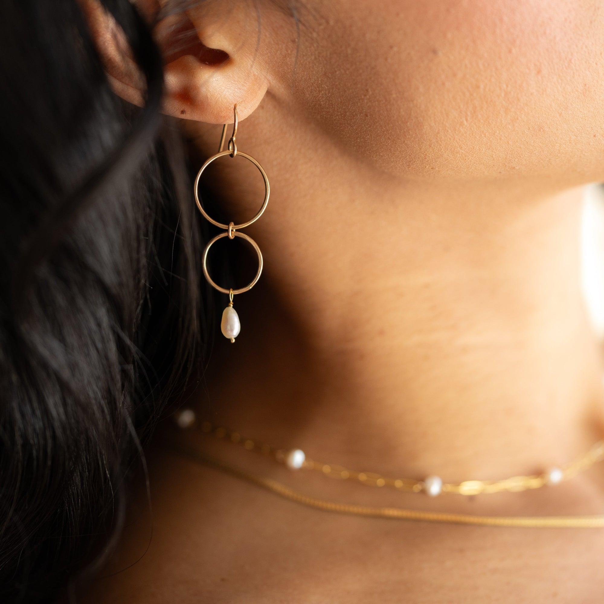Ava Pearl Drop Earrings with minimalist gold ear wires and dangling freshwater pearls.