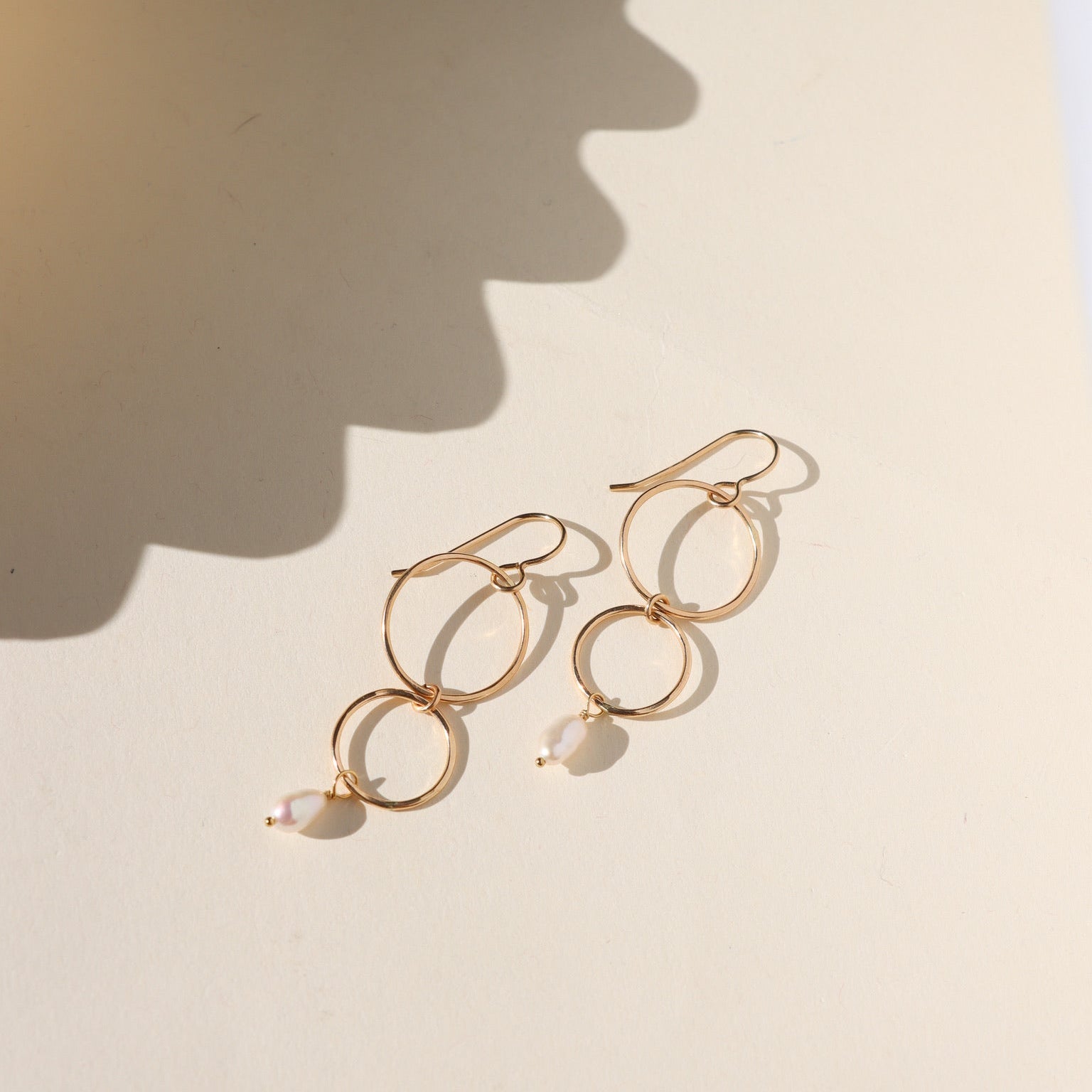 Ava Pearl Drop Earrings with minimalist gold ear wires and dangling freshwater pearls.