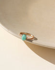 A 6x8mm amazonite gemstone set in a 14k gold fill serrated bezel. The ring is displayed on a cream dish. 