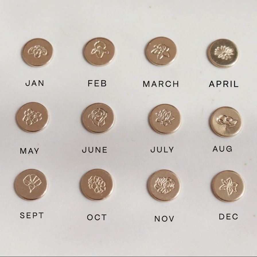 Examples of each birth flower available to be hand stamped onto a keepsake ring, including roses, carnations, daisy, lotus, poppy, among others.