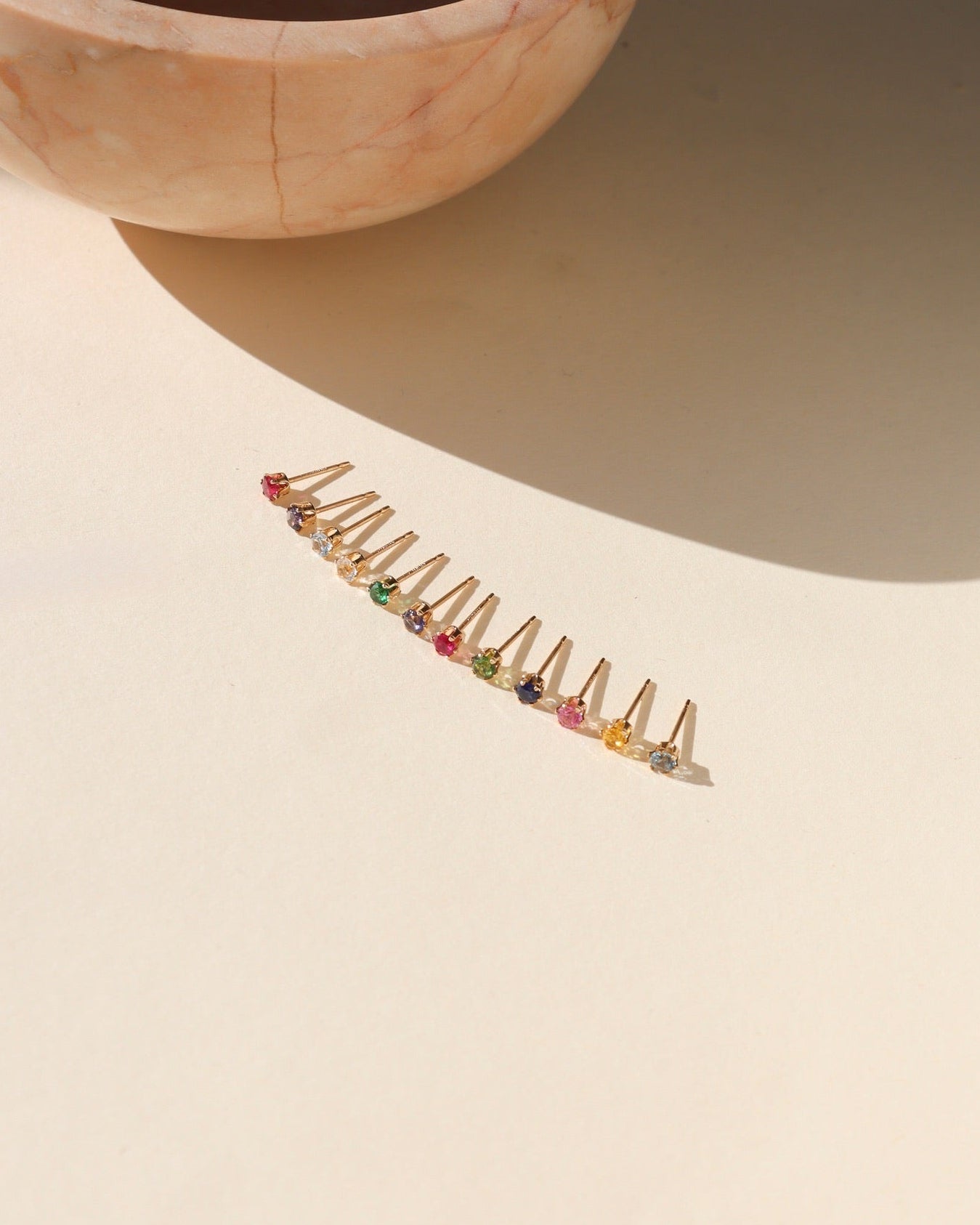 group photo of 14k gold fill birthstone prong stud earrings featuring 3mm gemstones on a light surface