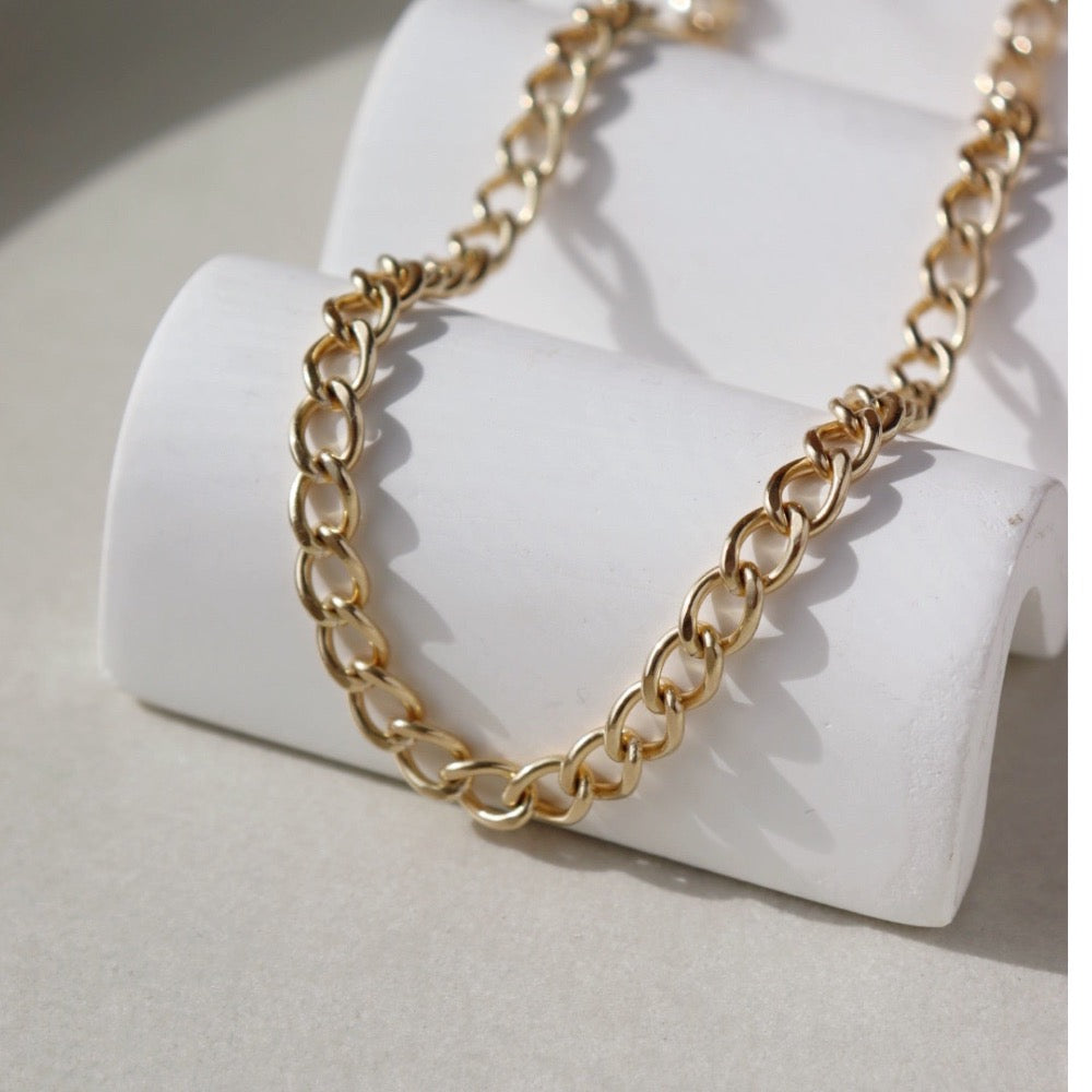 Bold and chunky 14k gold filled curb chain with a lobster clasp and 2" extender chain to make the necklace adjustable from 14" to 16". Alexandra Choker, handmade by Token Jewelry in Eau Claire, WI jewelry store near me, permanent jewelry, jewelry repair near me, rings, earrings, necklace, bracelet, gold chain, gemstones, rose gold