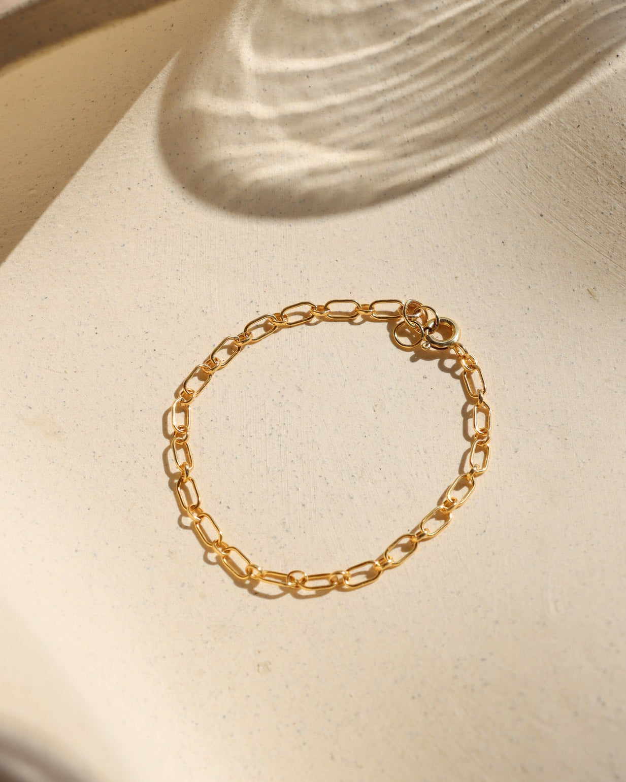 14k gold fill chain bracelet on a light dish