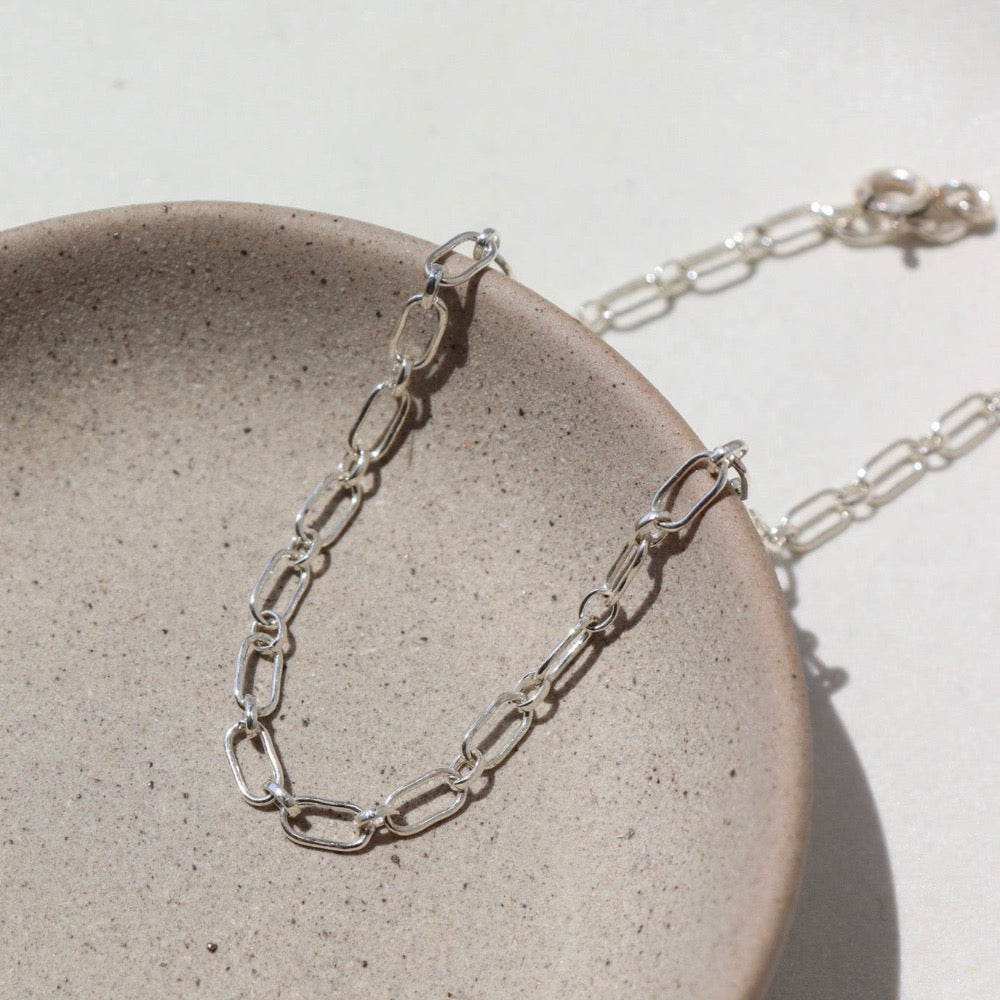 Brooklyn Bracelet in 925 Sterling silver on a gray plate in the sunlight