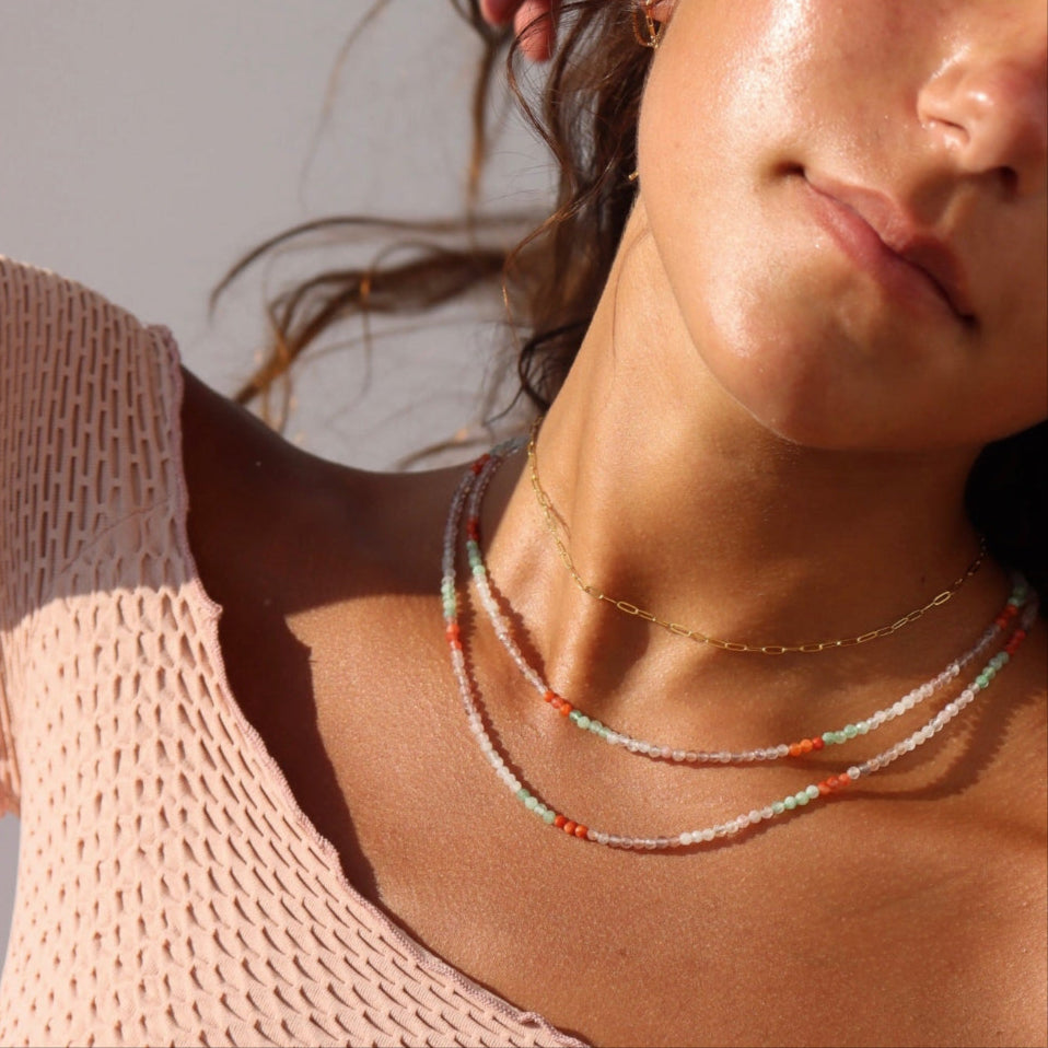Model wearing  full strand beaded necklace with moonstone, chrysoprase, and carnelian gemstones