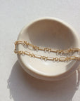 Callie Bracelet by token jewelry on a white ring dish