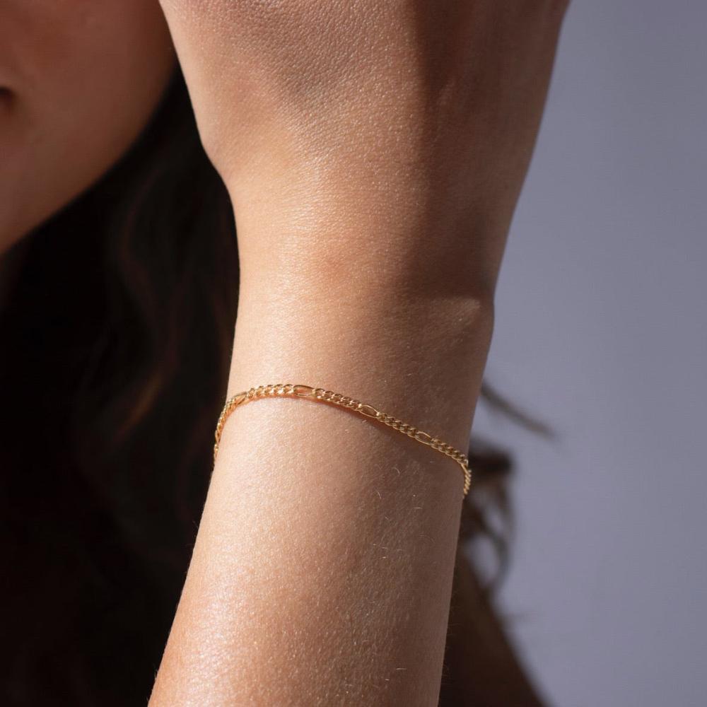 Model wearing 14k gold fill figaro chain bracelet
