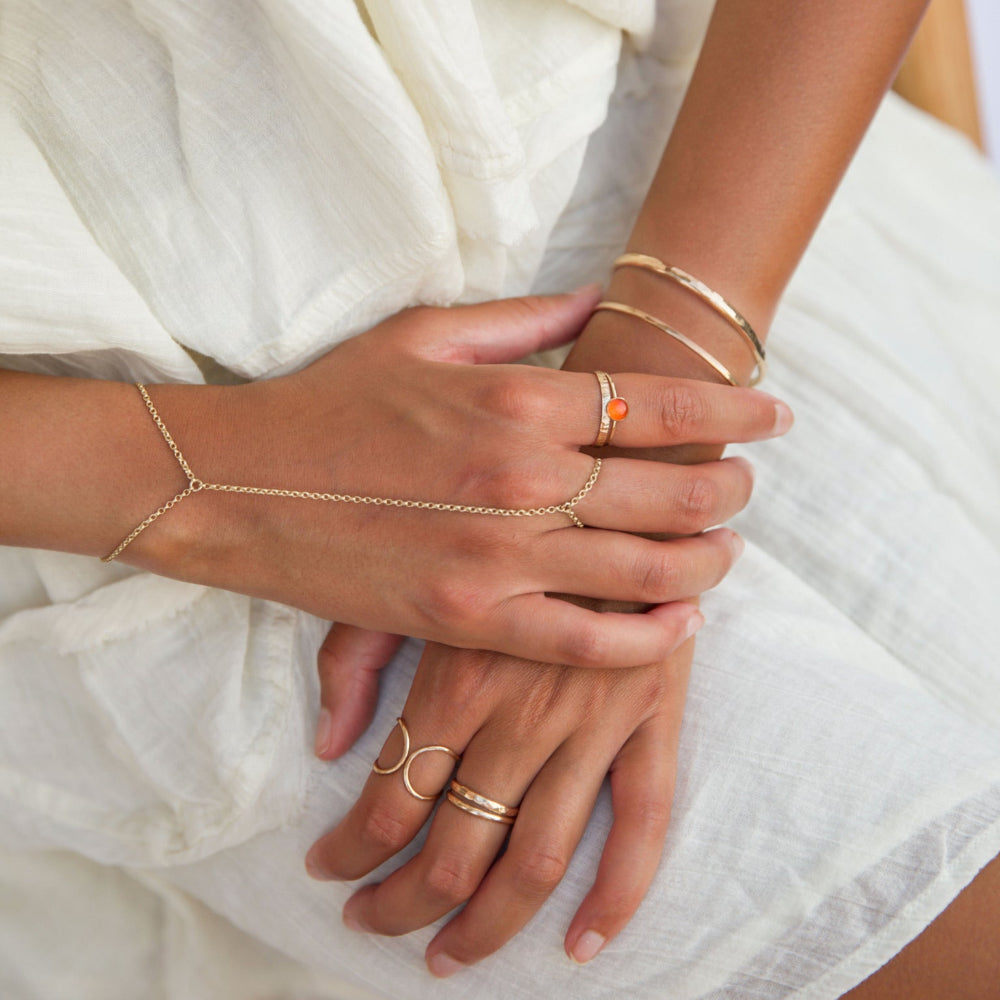 Model wearing fiery carnelian glow ring in gold fill setting
