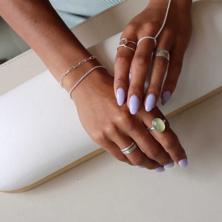 model wearing sterling silver hand chain with other sterling silver jewelry 