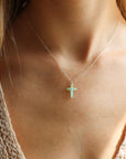 model wearing sterling silver delicate chain necklace with Chrysoprase Cross charm