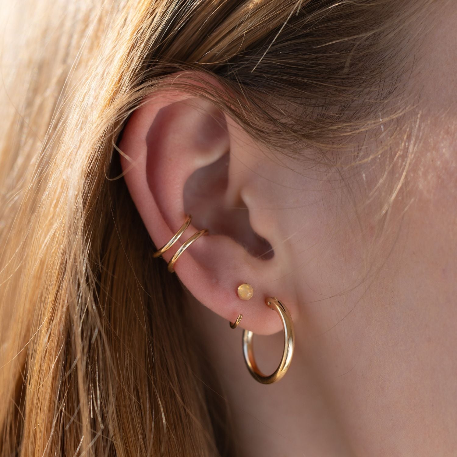 model wearing 14k gold fill ear cuff with hoops and huggies