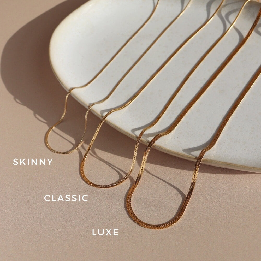 variety of 14k gold filled herringbone chains with lobster clasp closures available at Token Jewelry in Eau Claire, WI