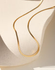 14k gold fill herringbone chain necklace on a light dish