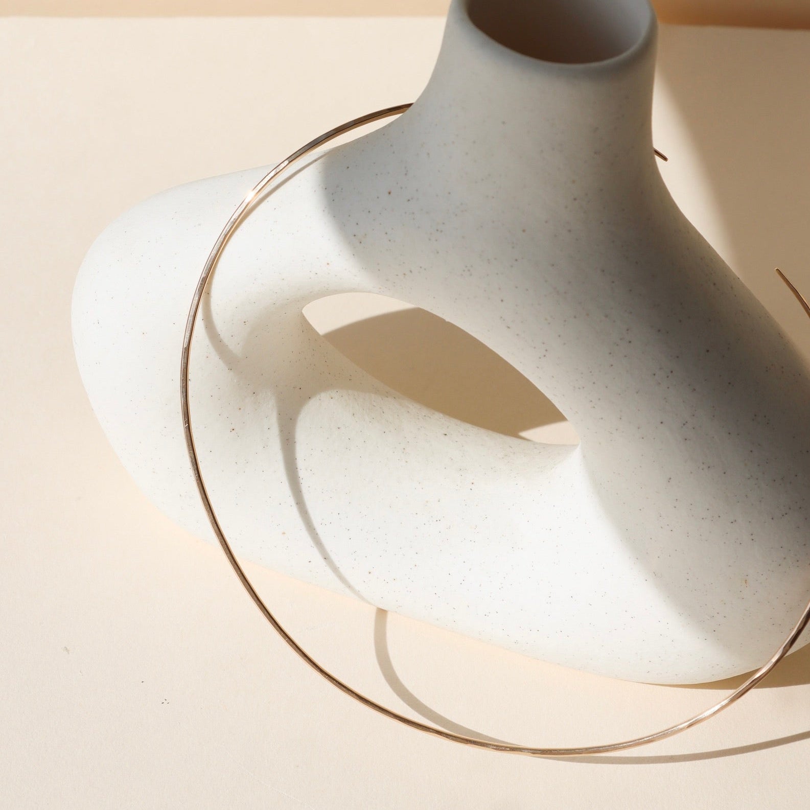 14k gold fill wire collarbone necklace on a light vase