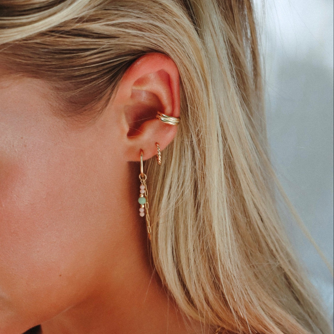 model wearing 14k gold fill hoops with coral and chryoprase beads and chain with 14k gold fill hoops and ear cuff